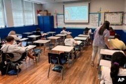 Math teacher Cheyenne Crider helps a seventh-grade student with a math problem at Piedmont Middle School in Piedmont, Ala., on Thursday, Aug. 31, 2023. (Trisha Powell Crain/AL.com via AP)