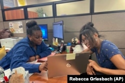FILE - Success Coach Latasha Wiley, left, helps first-year student Amare Porter, right, with her class schedule at Chattahoochee Valley Community College's advising center on Feb. 23, 2023. (Rebecca Griesbach/Press-Register via AP)