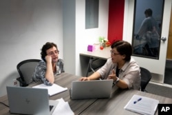 Robin Kolodny, left, a political science professor, works with Eunsook Ha Rhee, an associate professor of instruction, during a faculty teaching circle on artificial intelligence on Wednesday, Aug. 9, 2023, at Temple University in Philadelphia. (AP Photo/Joe Lamberti)
