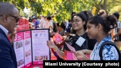 FILE - International students at Miami University in Ohio receive information about activities before the school year starts.