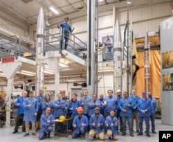 This NASA photo show agency workers standing in front of three APEP rockets at NASA Wallops Flight Facility on Wallops Island, Va., on Feb. 21, 2024. (Berit Bland/NASA via AP)