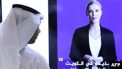A journalist watches an introductory video by the 'artificial intelligence' anchor Fedha on the twitter account of Kuwait News service, in Kuwait City on April 9, 2023. (Photo by YASSER AL-ZAYYAT / AFP)