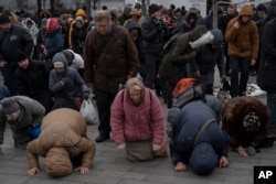 People pray in the Kyiv Pechersk Lavra monastery complex in Kyiv, Ukraine, March 29, 2023. (AP Photo/Andrew Kravchenko)