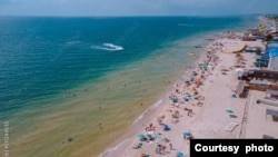 FILE - People on vacation enjoy the beach at Kyrylivka on the Sea of Azov in southern Ukraine. (Adobe Stock Photo by Denis Chubchenko)