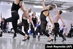 Amarisa LeBar, center, a Radio City Rockette, leads students in a Rockettes Precision Dance Technique course Wednesday, Feb. 8, 2023, at the Boston Conservatory at Berklee in Boston. (AP Photo/Josh Reynolds)