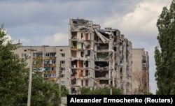 FILE - A view shows apartment buildings damaged during Ukraine-Russia conflict in the town of Popasna in the Luhansk region, Ukraine July 14, 2022. (REUTERS/Alexander Ermochenko)