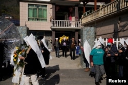 Relatives and neighbours attend the funeral of a woman surnamed Liu, as coronavirus disease (COVID-19) outbreak continues, at a village in Tonglu county, Zhejiang province, China, January 9, 2023. (REUTERS/Aly Song)