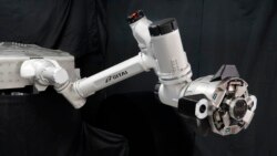 This undated photo provided by Toyota Motor Corp. shows a robotic arm developed for a vehicle called "Lunar Cruiser" to explore the lunar surface. (Toyota Motor Corp. via AP)