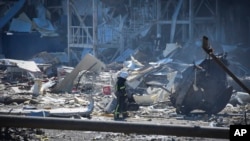 An Ukrainian firefighter works near a destroyed building on the outskirts of Odesa, Ukraine, Tuesday, May 10, 2022. (Max Pshybyshevsky)