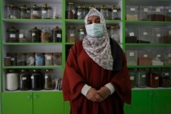 Semsinur Gafur, an ethnic Uyghur who fled from China to Turkey, poses for The Associated Press, in Istanbul, Tuesday, June 1, 2021. (AP Photo/Mehmet Guzel)