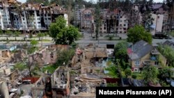 Damaged buildings ruined by attacks are seen in Irpin, on the outskirts of Kyiv, Ukraine, Thursday, May 26, 2022. (AP Photo/Natacha Pisarenko)