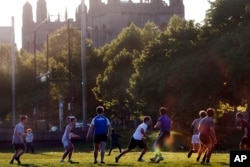 University of Chicago men's rugby team players practice near the campus in Chicago, May 6, 2021. (AP Photo/Shafkat Anowar, File)