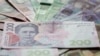 Ukrainian hryvnia banknotes are seen in a photo illustration shot in Kiev, August 6, 2014. Picture taken August 6, 2014. REUTERS/Konstantin Chernichkin (UKRAINE - Tags: BUSINESS) - RTR49DML