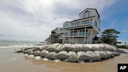 Un homme a placé des sacs de sable autour à sa maison pour la protéger de l'ouragan Florence annoncé à North Topsail Beach, Caroline du Nord, le 12 septembre 2018.