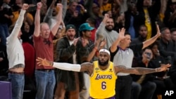 LeBron James celebrates after scoring to pass Kareem Abdul-Jabbar to become the NBA's all-time leading scorer on Feb. 7, 2023. (AP Photo/Mark J. Terrill)