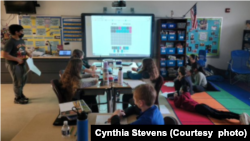 Children playing computer game Nerdle in their classroom