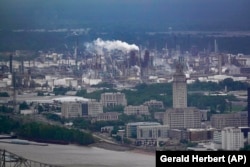 Exxon Mobil’s scientists were remarkably accurate in their predictions about global warming, even as the company made public statements that contradicted its own scientists' conclusions, a new study says. (AP Photo/Gerald Herbert)