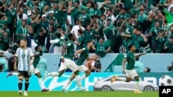Saudi Arabia's Salem Al-Dawsari, right, celebrates after scoring his side's second goal during the World Cup group C soccer match between Argentina and Saudi Arabia at the Lusail Stadium in Lusail, Qatar, Tuesday, Nov. 22, 2022. (AP Photo/Natacha Pisarenko)