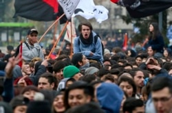 Youths take part in a march demanding the government overhaul the education funding system that would include canceling student loan debt, in Santiago, Chile, Wednesday, June 21, 2017.