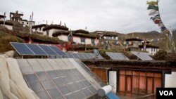In this Aug. 17, 2016, photo, solar panels are installed on the rooftop of a traditional house in the mountain village of Demul, Spiti Valley, India.