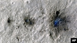This undated photo released by NASA shows craters that were formed by a Sept. 5, 2021, by a meteoroid impact on Mars, the first to be detected by NASA’s InSight lander. (NASA/JPL-Caltech/University of Arizona via AP)