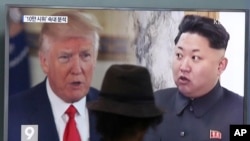 Un homme regarde un écran de télévision montrant le président Donald Trump et le dirigeant nord-coréen Kim Jong Un lors d'un programme d'information à la gare de Séoul à Séoul, Corée du Sud, 10 août 2017. 