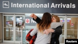 FILE - Mahnaz Kanani Zadeh, right, is greeted by her niece Negin after traveling to the U.S. from Iran at Logan Airport in Boston, Massachusetts, Feb. 6, 2017. (REUTERS/Brian Snyder)