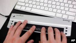 In this Nov. 23, 2009 photo, Victor Tsaran, co-director of Yahoo's "Accessibility Lab", uses a Braille keyboard in his lab at Yahoo Inc. headquarters in Sunnyvale, Calif. (AP Photo/Paul Sakuma)