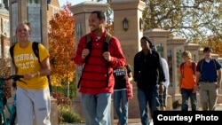 Students walk outside at Michigan State University, one of 11 member institutions of the University Innovation Alliance.