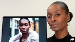 Fashion model Alexsandrah poses with a computer showing an AI generated image of her, in London, Friday, March 29, 2024. (AP Photo/Kirsty Wigglesworth)
