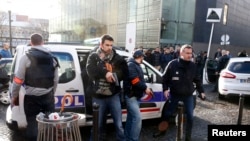 French police secure the area after a man was shot dead at a police station in the 18th district in Paris, France, Jan. 7, 2016.