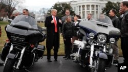 FILE - President Donald Trump give a 'thumbs-up' as he meets with Harley Davidson executives and union representatives on the South Lawn of the White House in Washington, Thursday, Feb. 2, 2017. (AP Photo/Pablo Martinez Monsivais)