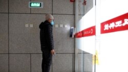 A man has his face scanned by a facial recognition device that identifies people when they wear masks to gain entrance to the office of Chinese electronics manufacturer Hanwang Technology in Beijing. Picture taken March 6, 2020. (Reuters/Thomas Peter)
