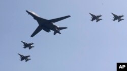 FILE - U.S. B-1 bomber, center, flies over Osan Air Base with U.S. jets in Pyeongtaek, South Korea, Tuesday, Sept. 13, 2016. (AP Photo/Lee Jin-man)