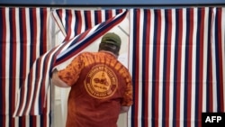 A voter enters the voting booth in Manchester, New Hampshire, Nov. 4, 2014. 