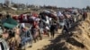 Palestinians, displaced to the south at Israel's order during the war, wait to have their vehicles inspected by the Egyptian-Qatari committee as they return to their homes in northern Gaza, near Gaza City, Jan. 27, 2025. 