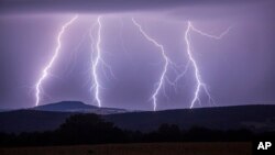 In this photo taken Wednesday, Aug. 9, 2017 a strike of lightning illuminates the sky over Annaberg-Buchholzer, southeastern Germany. (Bernd Maerz/dpa via AP)