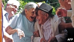 Paraguayan Anacleto Escobar (R) and his wife Cayetana Roman, smile during a ceremony coinciding with his 100th birthday in which they received a house.
