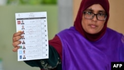 2023年9月9日马尔代夫总统选举在马累举行，一名选举工作人员在计票时展示选票