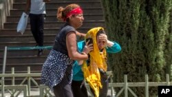 Family members of the victims involved in a plane crash react at Addis Ababa international airport Sunday, March 10, 2019.
