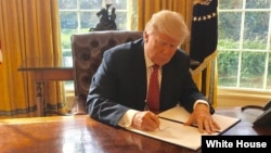 White House Press Secretary Sean Spicer tweeted this photo of President Donald Trump signing a new executive order to ban travelers from six Muslim-majority nations on Mar. 6, 2017. The media was not invited to see the president signing the order.