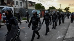 Riot police walk the streets after a demonstration against the government of President Miguel Diaz-Canel in Arroyo Naranjo Municipality, Havana, July 12, 2021.