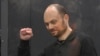 FILE - Russian opposition activist Vladimir Kara-Murza gestures while standing in a defendant's cage at Moscow City Court in Moscow, July 31, 2023.