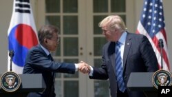 President Donald Trump and South Korean President Moon Jae-in shakes hands in the Rose Garden of the White House in Washington, Friday, June 30, 2017, after making statements. (AP Photo/Susan Walsh)