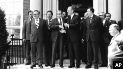 Soviet General Secretary Leonid Brezhnev shakes hands with President Ford after their first round of talks at the American Embassy in Helsinki, July 30, 1975. (AP Photo)
