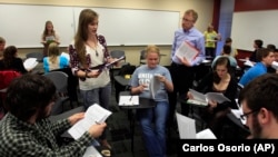 An academic advisor for the Alma College Model U.N. program listens to a student's presentation during class at Alma College, a tiny, north-central Michigan liberal arts school in Michigan.