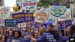 FILE - Members of 1199 Service Employees International Union march up Fifth Avenue in the annual Labor Day Parade in New York in 2015. (AP Photo/Bryan R. Smith)