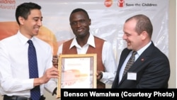 Dr. Benson Wamalwa (Center) receives an award from GSK-Save the Children Partnership.