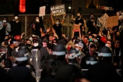NYPD officers face demonstrators after curfew during a protest against the death in Minneapolis police custody of George Floyd, in New York City, U.S., June 2, 2020. REUTERS/Brendan Mcdermid