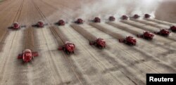 FILE - Workers harvest soybeans in a farm in the city of Tangara da Serra, Brazil, March 27, 2012.
